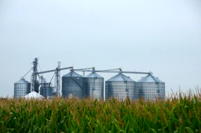 a farm with silos and silos in the foreground