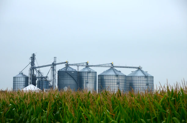 a farm with silos and silos in the foreground