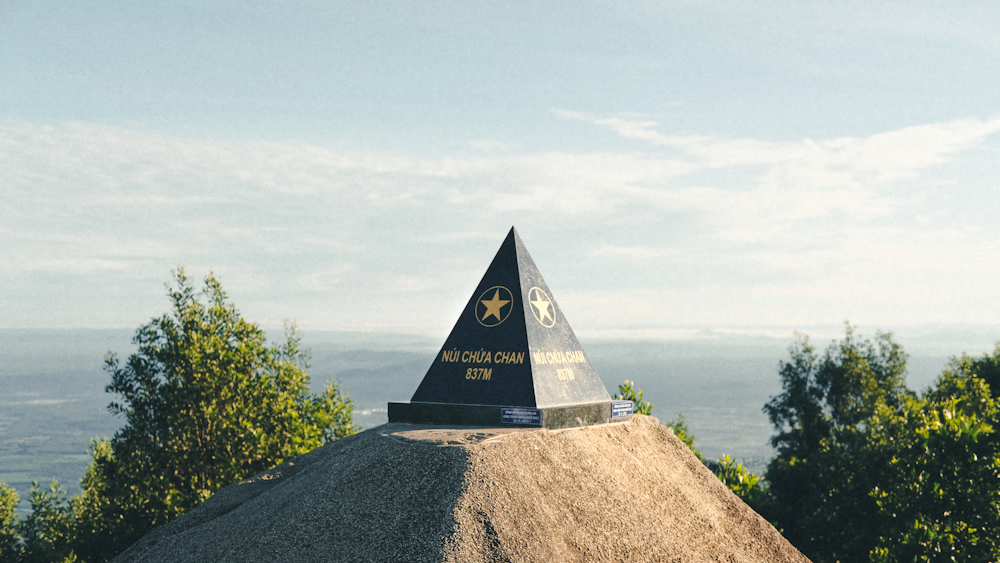 a large mound of dirt with a sign on top of it