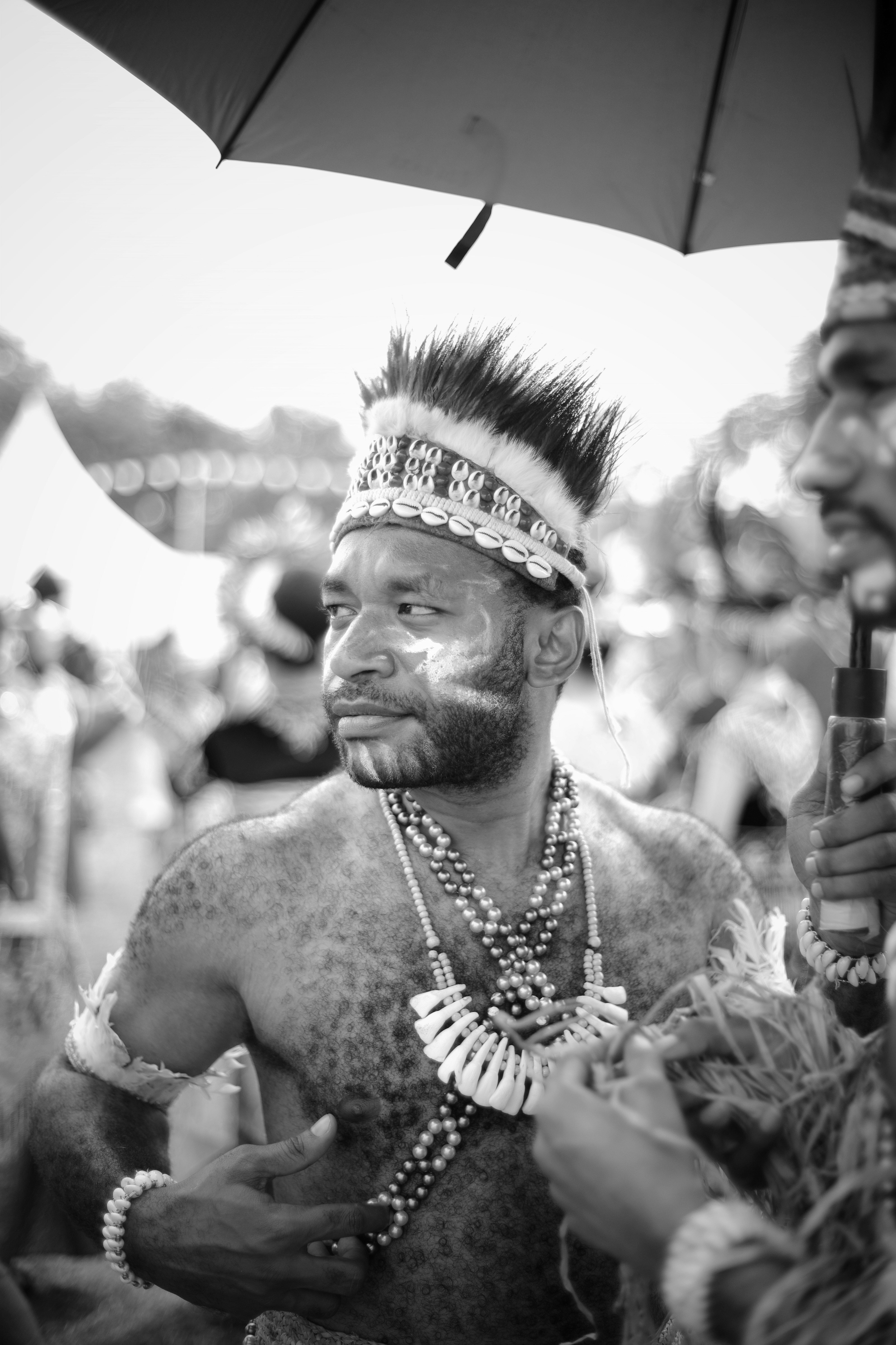 a man with a mohawk standing under an umbrella