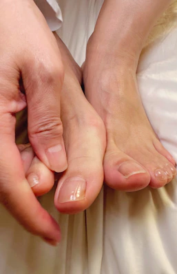 Close-up of a podiatrist's hands treating a patient's foot with gentle care.