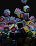 a pile of colorful cubes with social icons flying out of them