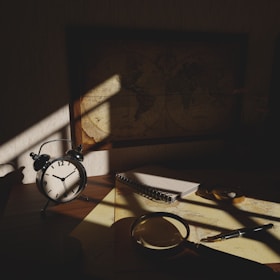 A serene detective’s desk with tarot cards and a magnifying glass under soft light.
