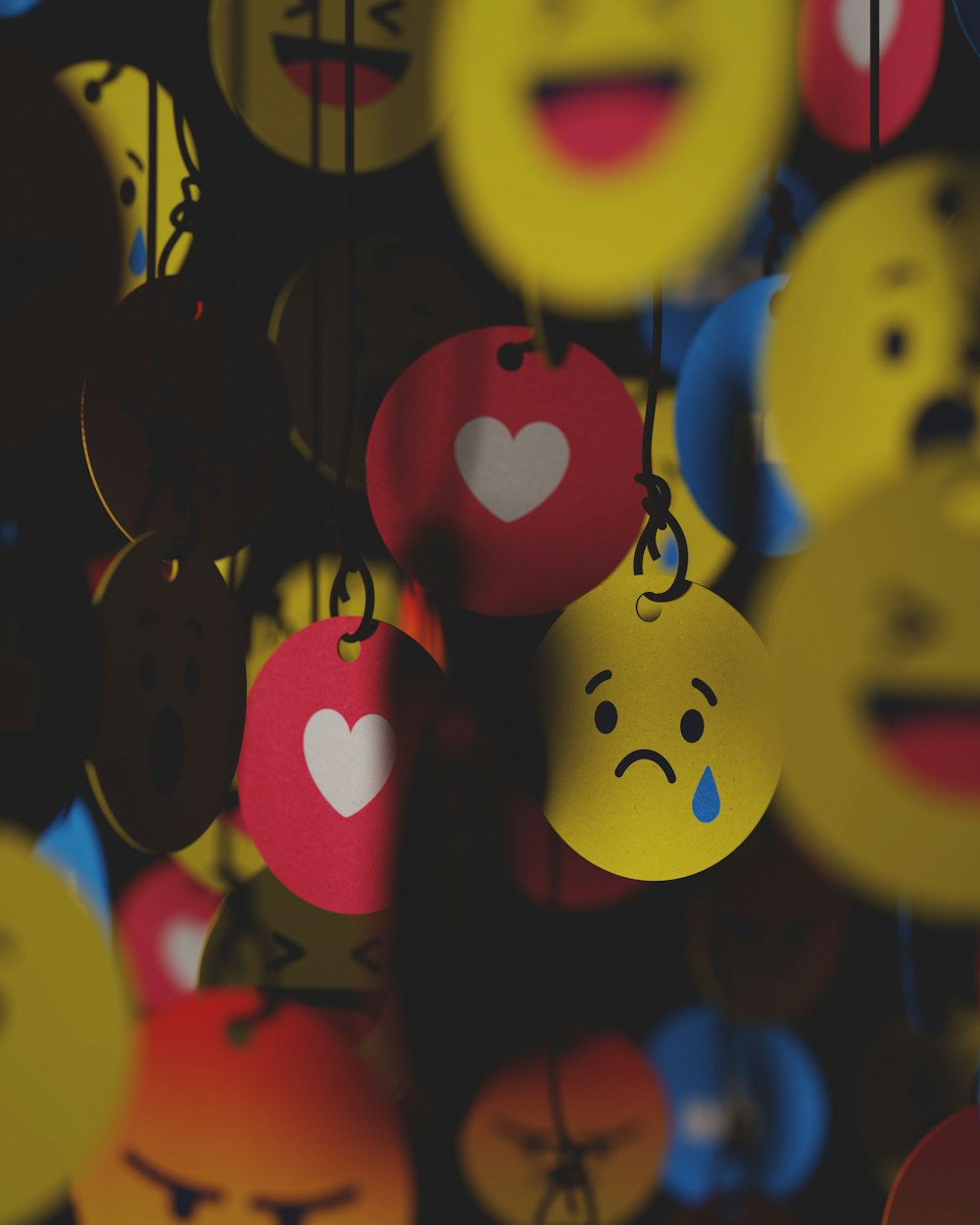 a bunch of smiley faces hanging from strings