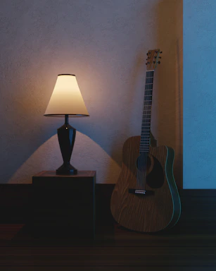 A cozy home studio with warm lighting, a guitar resting against a chair, and handwritten lyrics scattered on a wooden desk.