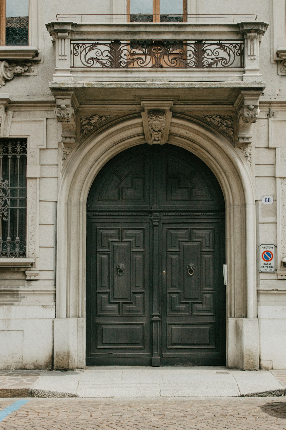 a couple of large black doors in front of a building