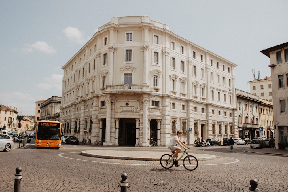 a person riding a bike in front of a building