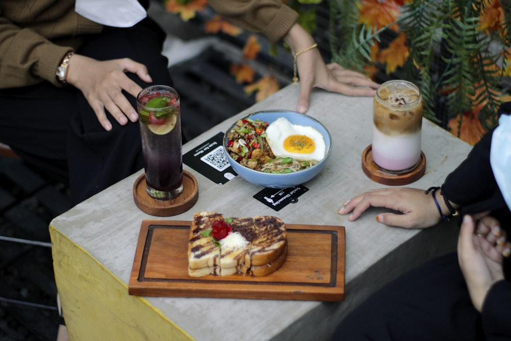 a table topped with plates of food and drinks