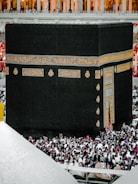 Close-up image of the Kaaba surrounded by worshippers in prayer.