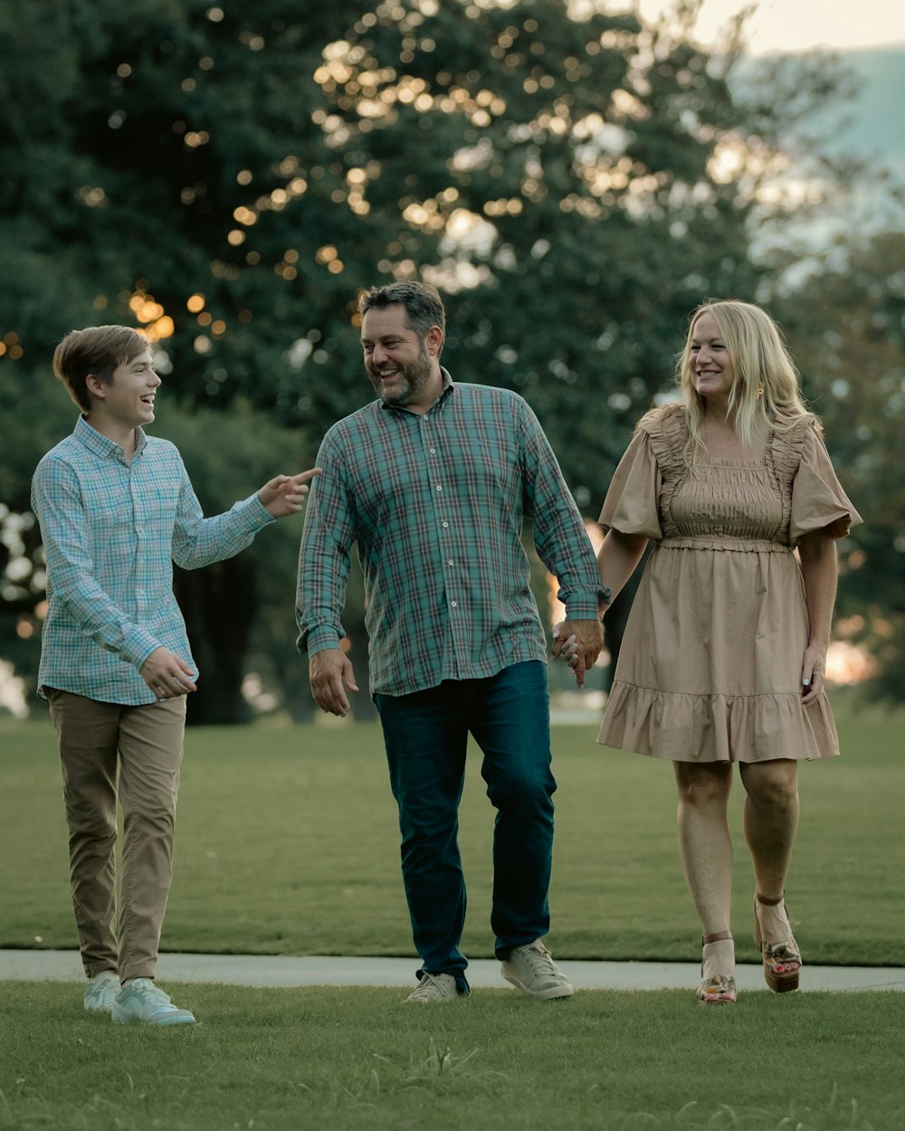 a man and a woman walking through a park