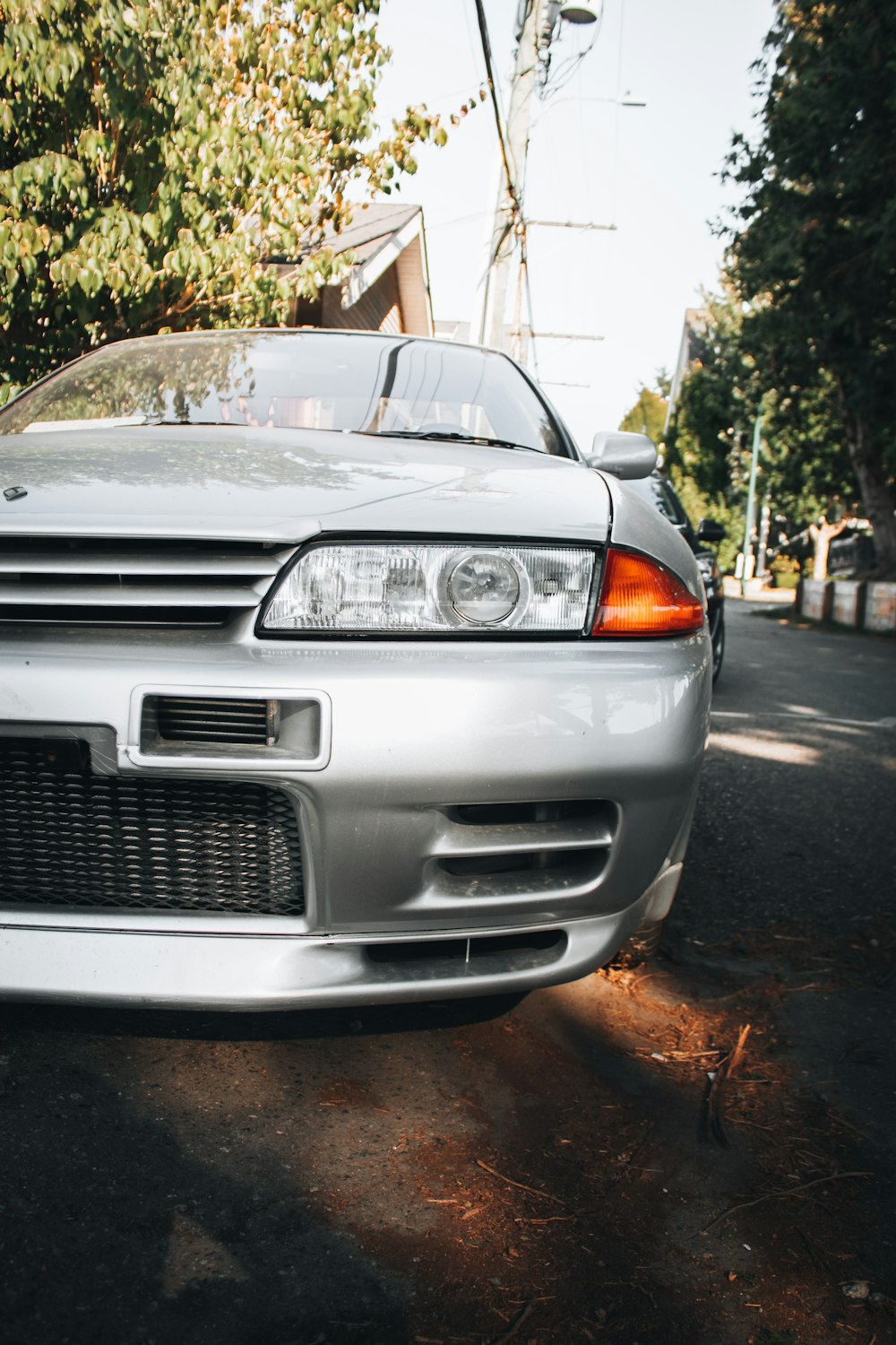 a silver car parked on the side of the road