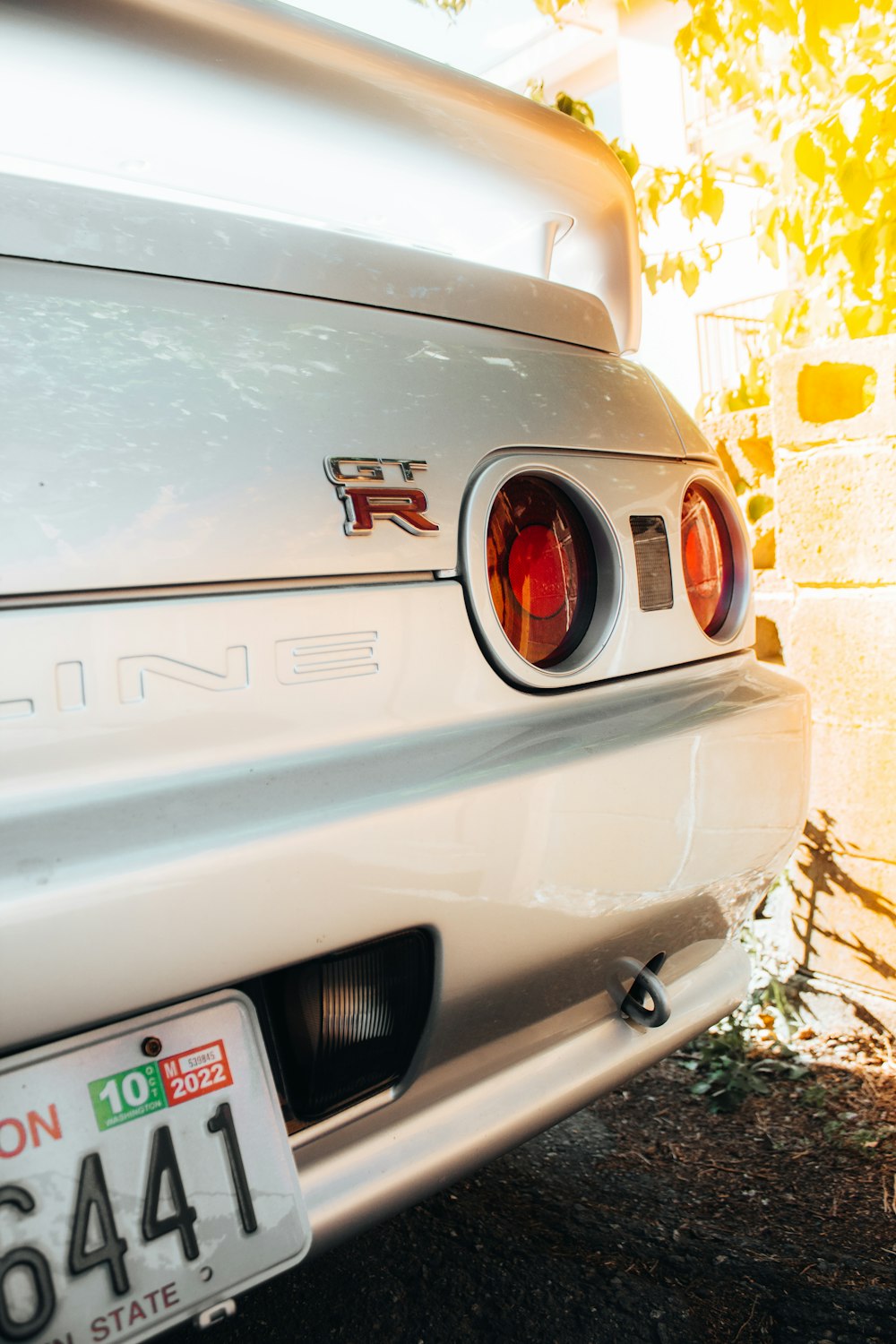 a close up of a white car with a license plate