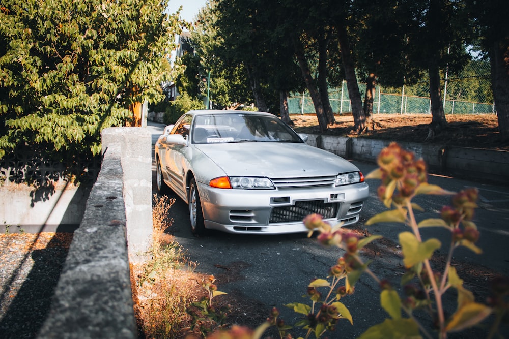 a white car parked on the side of a road