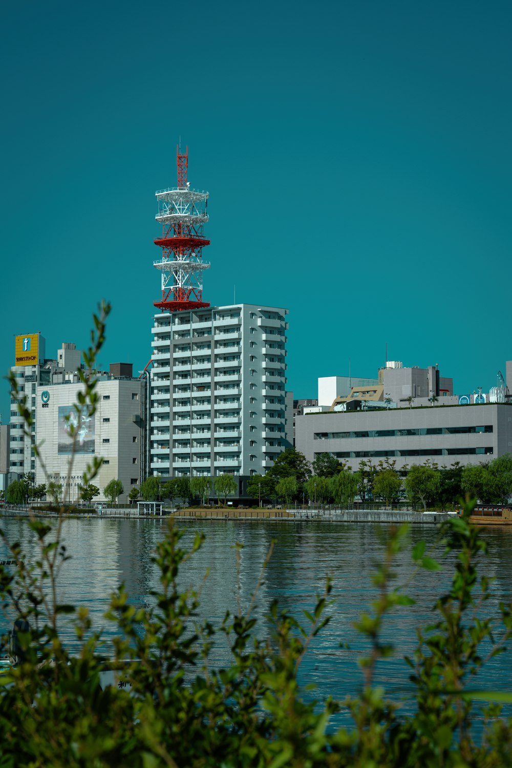 a very tall building sitting next to a body of water