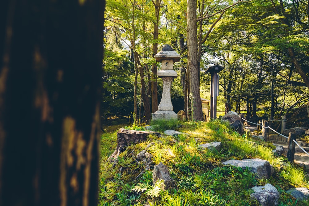 a stone lantern in the middle of a forest