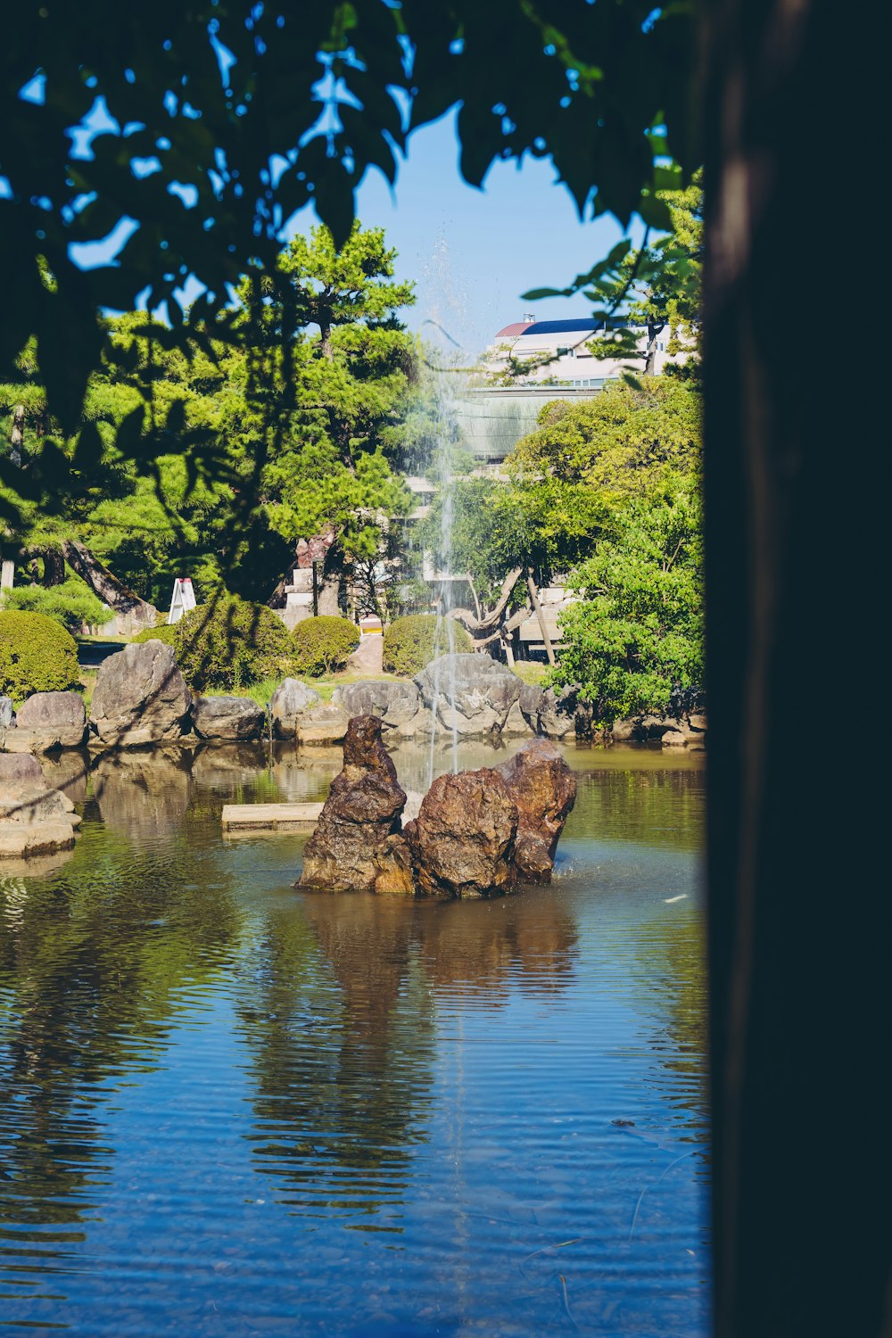 a pond with a fountain in the middle of it