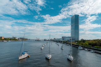 a group of boats floating on top of a river niigata city