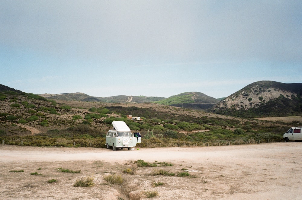 a van is parked on a dirt road