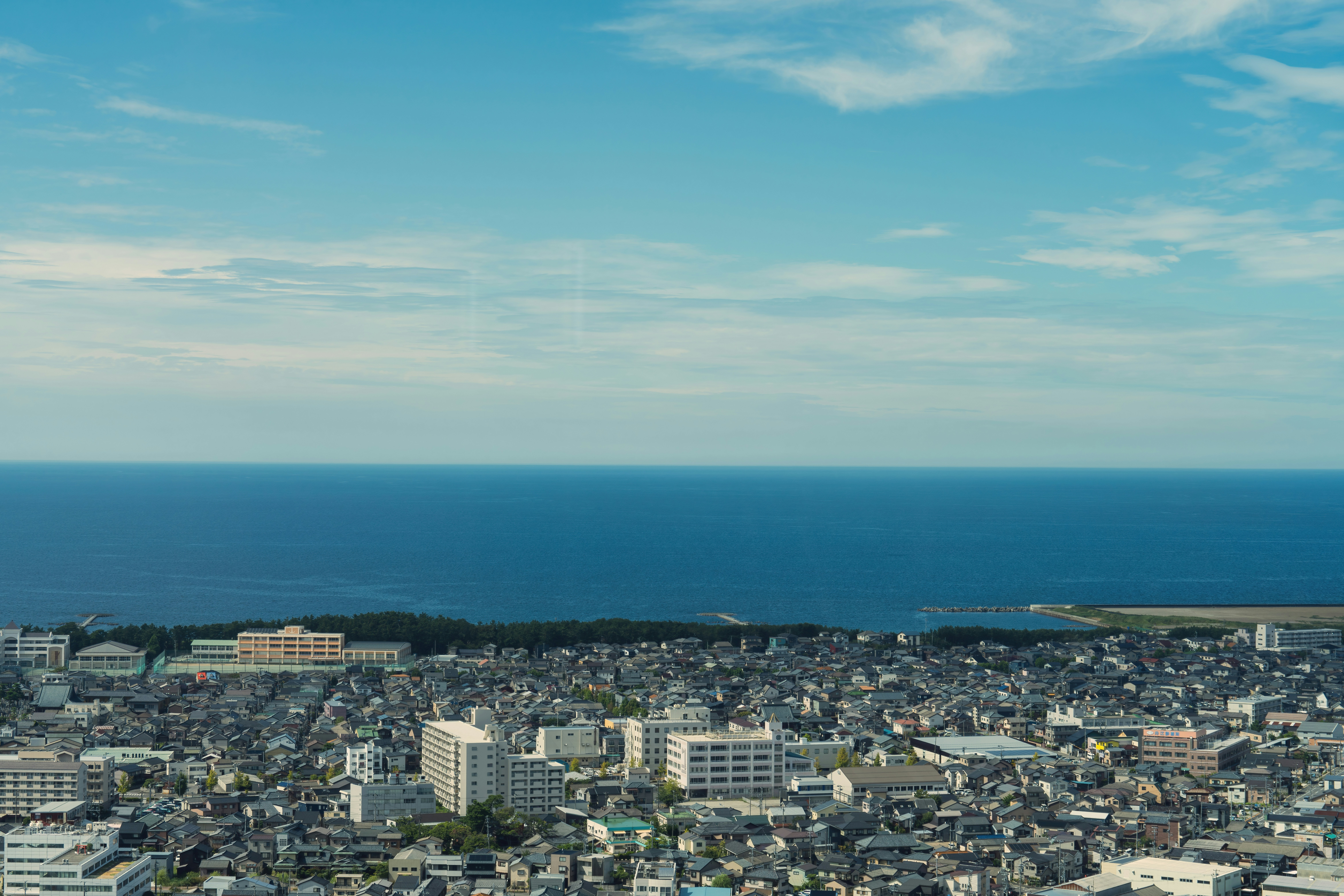 a view of a city with a body of water in the background