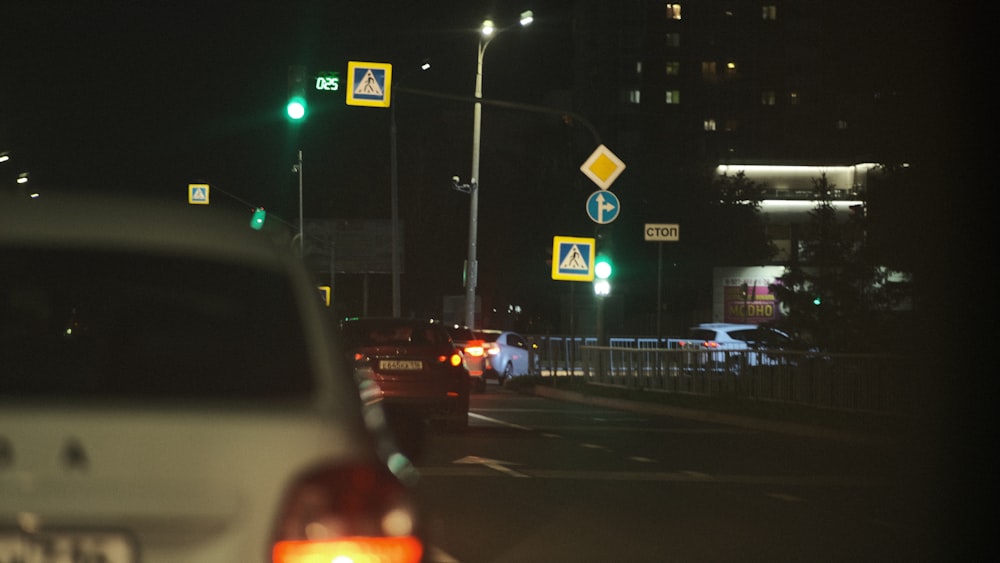 a car stopped at a green light at night