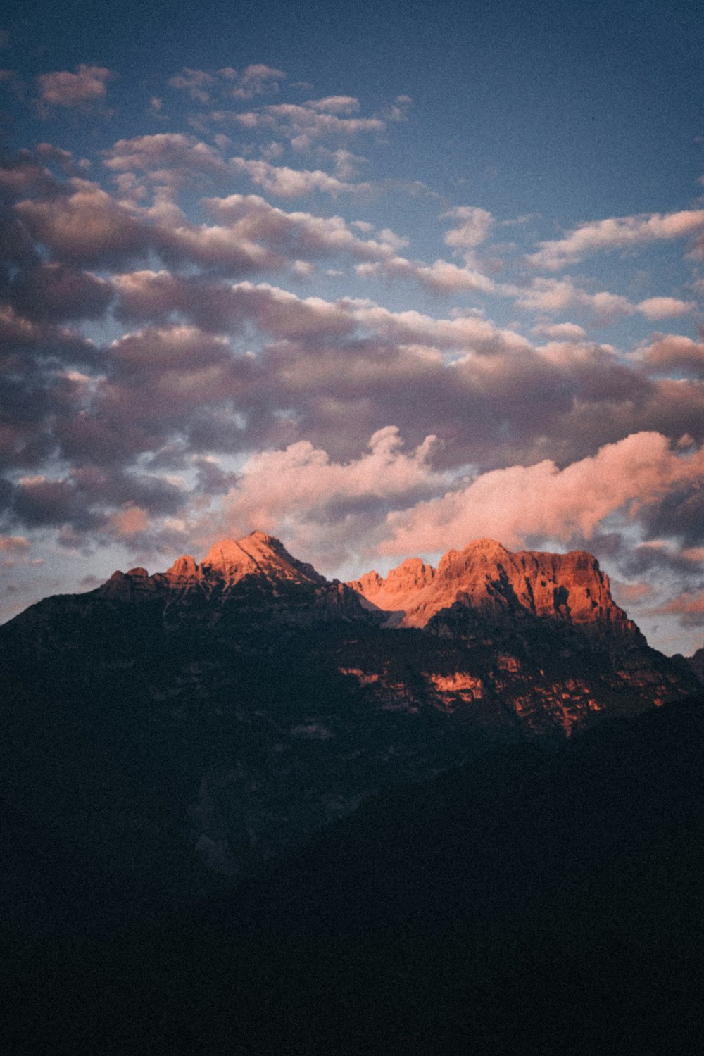 a view of a mountain with clouds in the sky