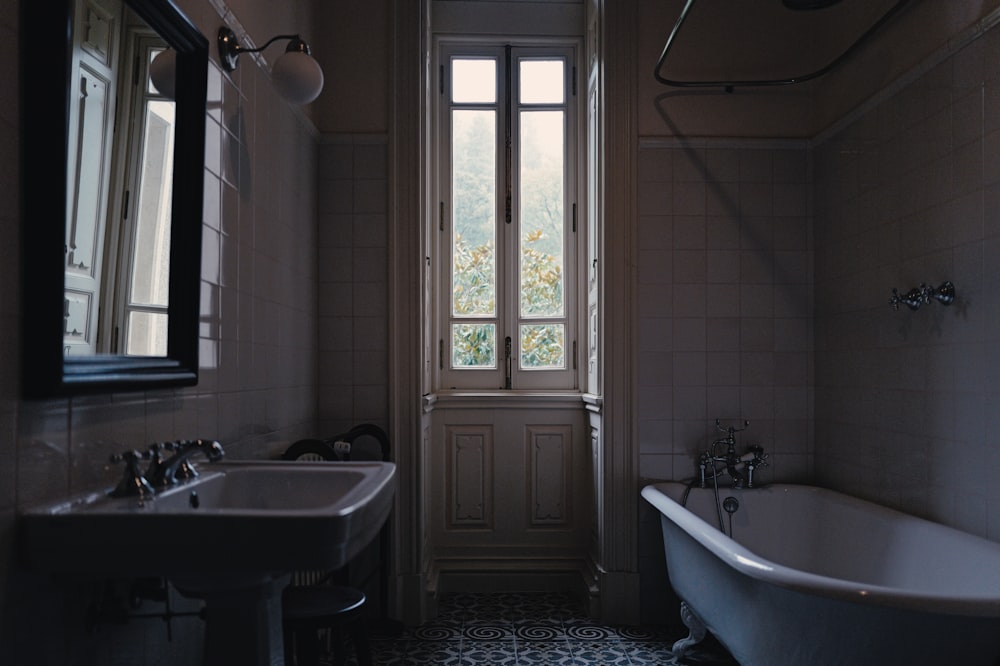 a bath room with a bath tub a sink and a mirror