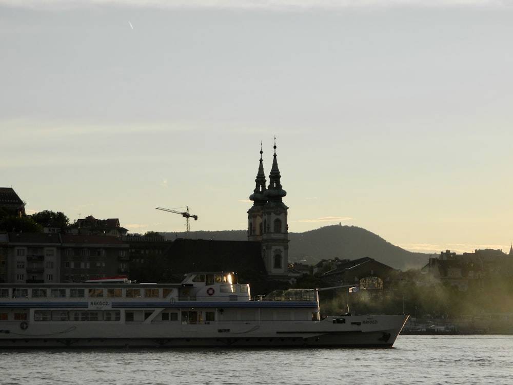 a large white boat floating on top of a river