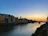 Sunset over the serene Garonne river with quaint village houses along the shore.