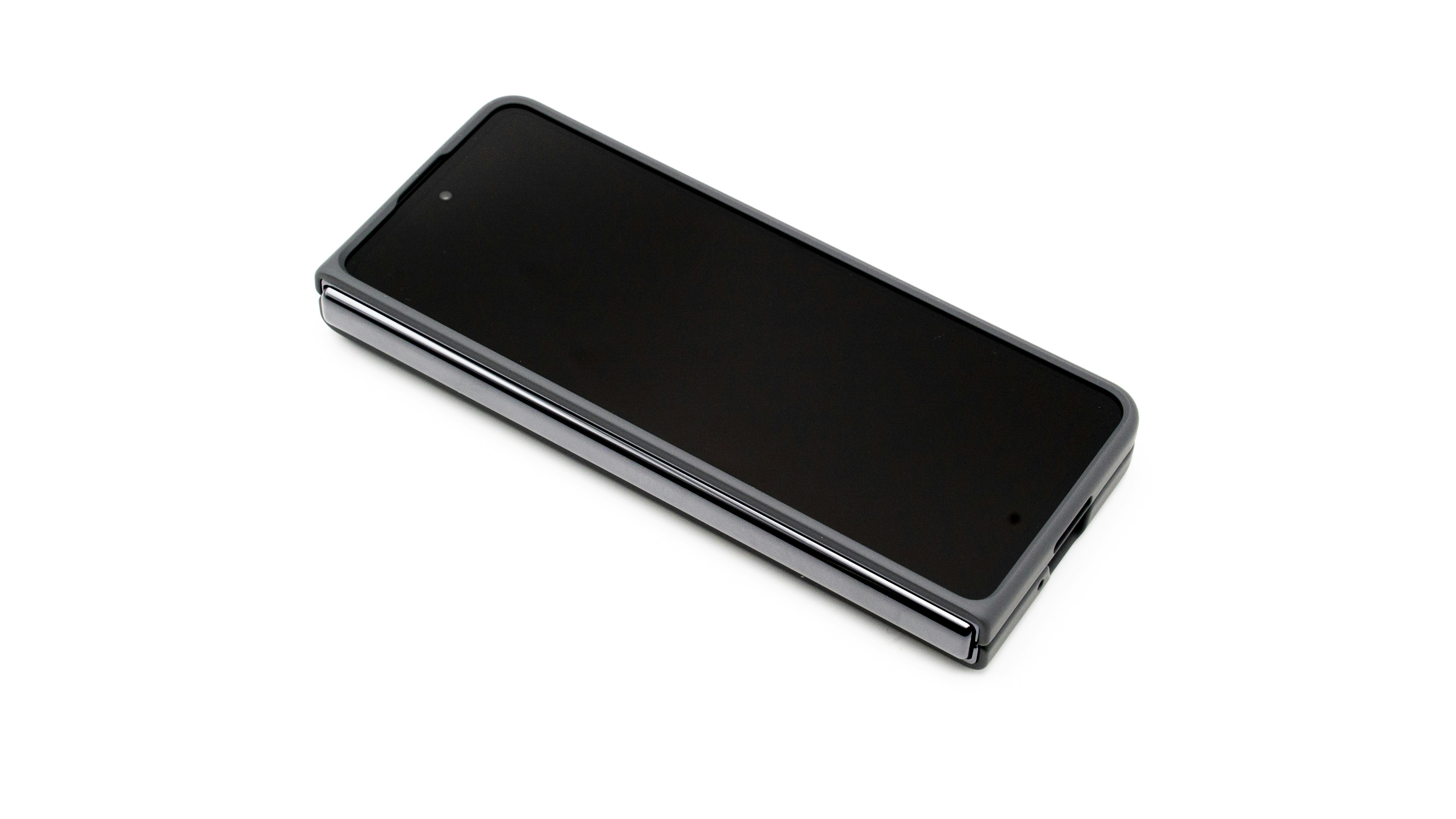 a close up of a cell phone on a white surface, Samsung Galaxy Fold 5 in s pen case, folded, screen up, centered on a white background