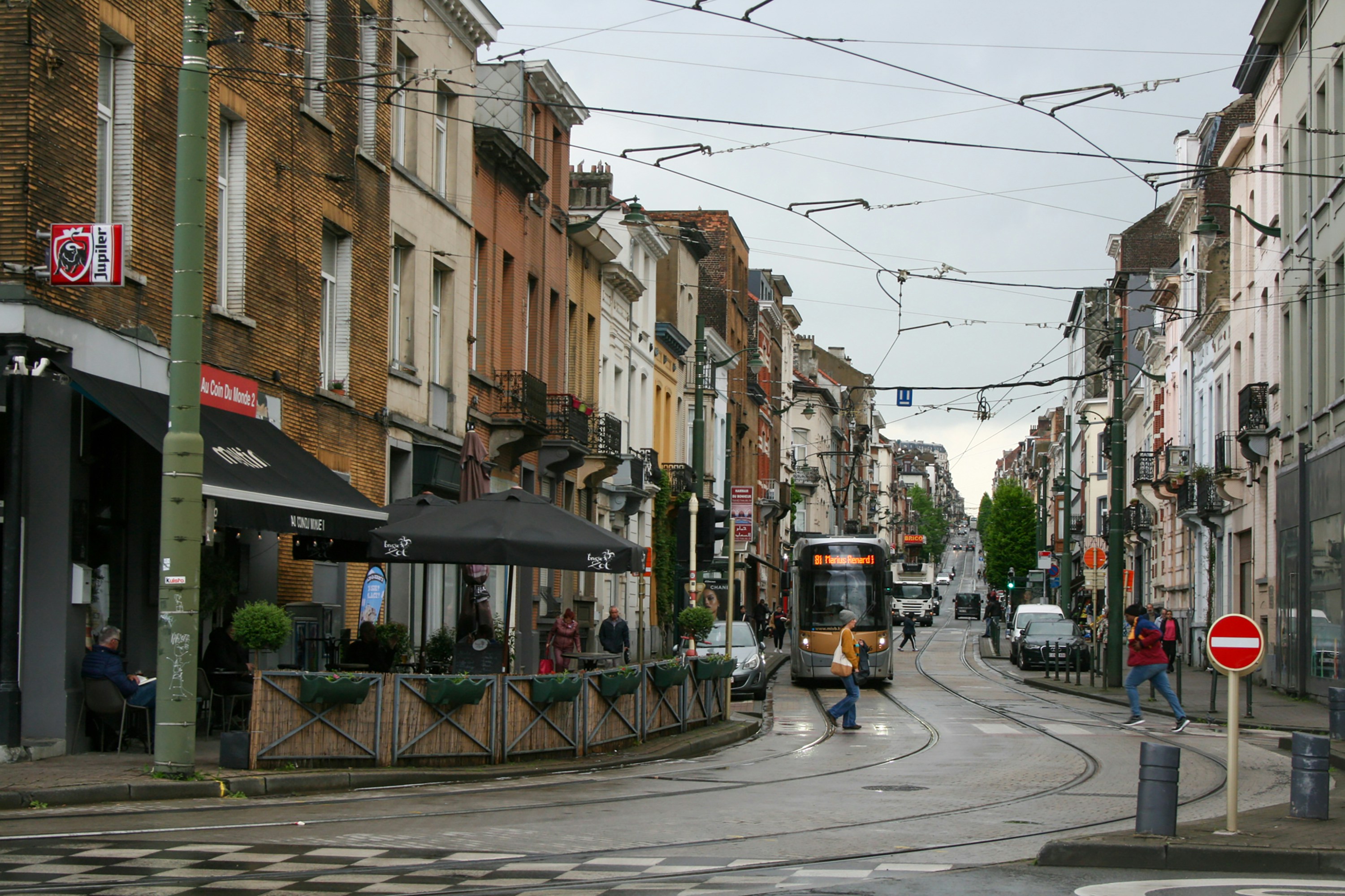 a street scene with a tram on the tracks