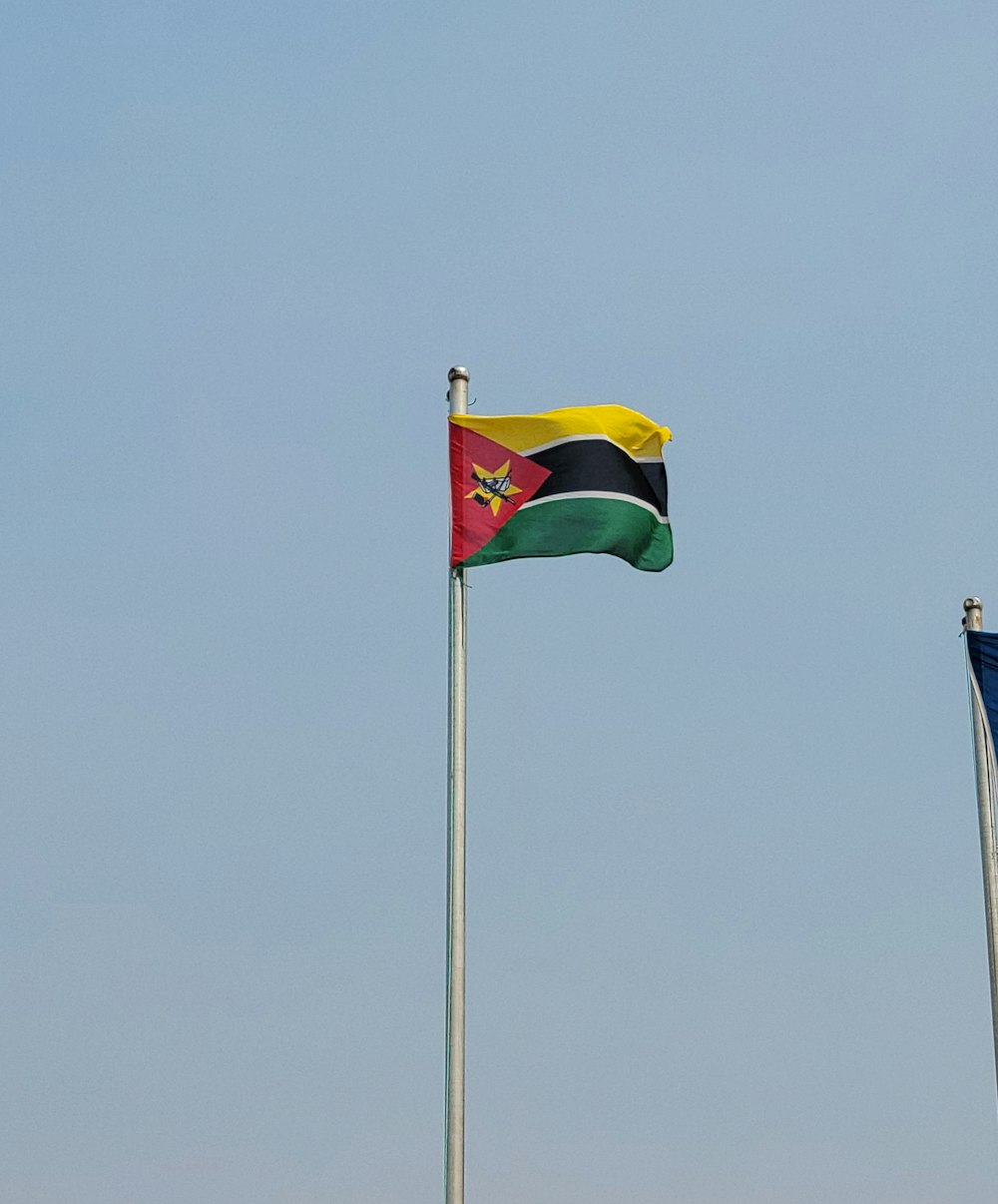 a couple of flags flying next to each other