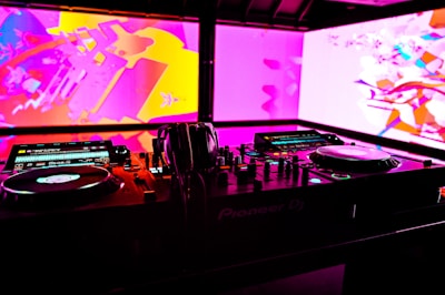 A vibrant DJ booth with colorful lights and equipment.