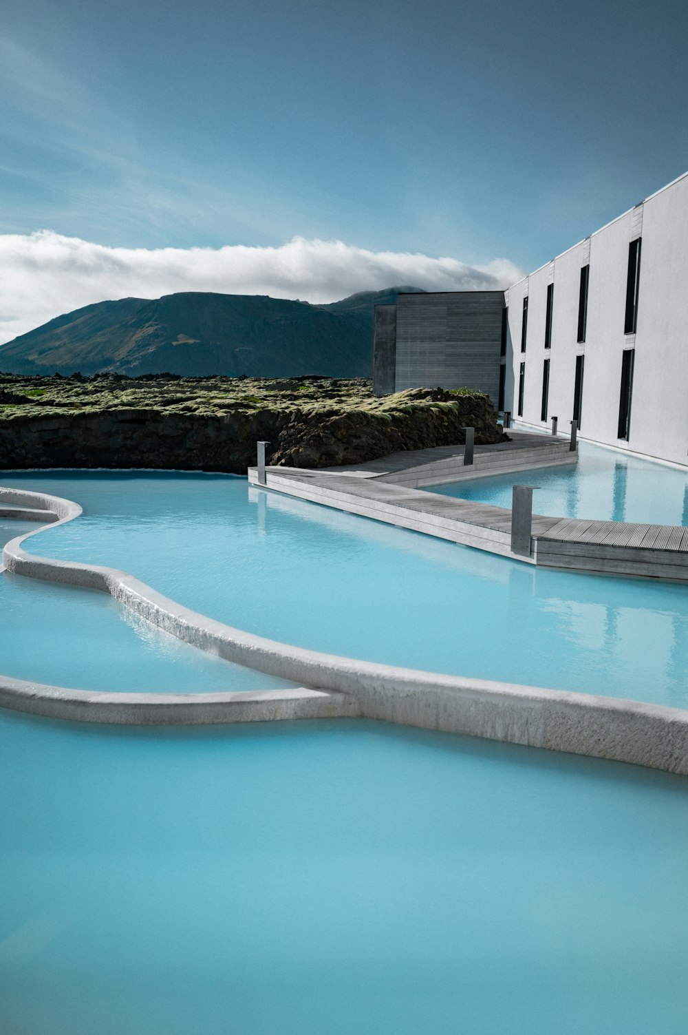 a large swimming pool with a building in the background