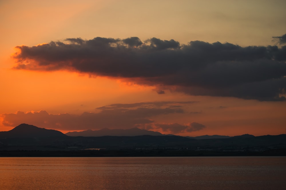 a large body of water under a cloudy sky