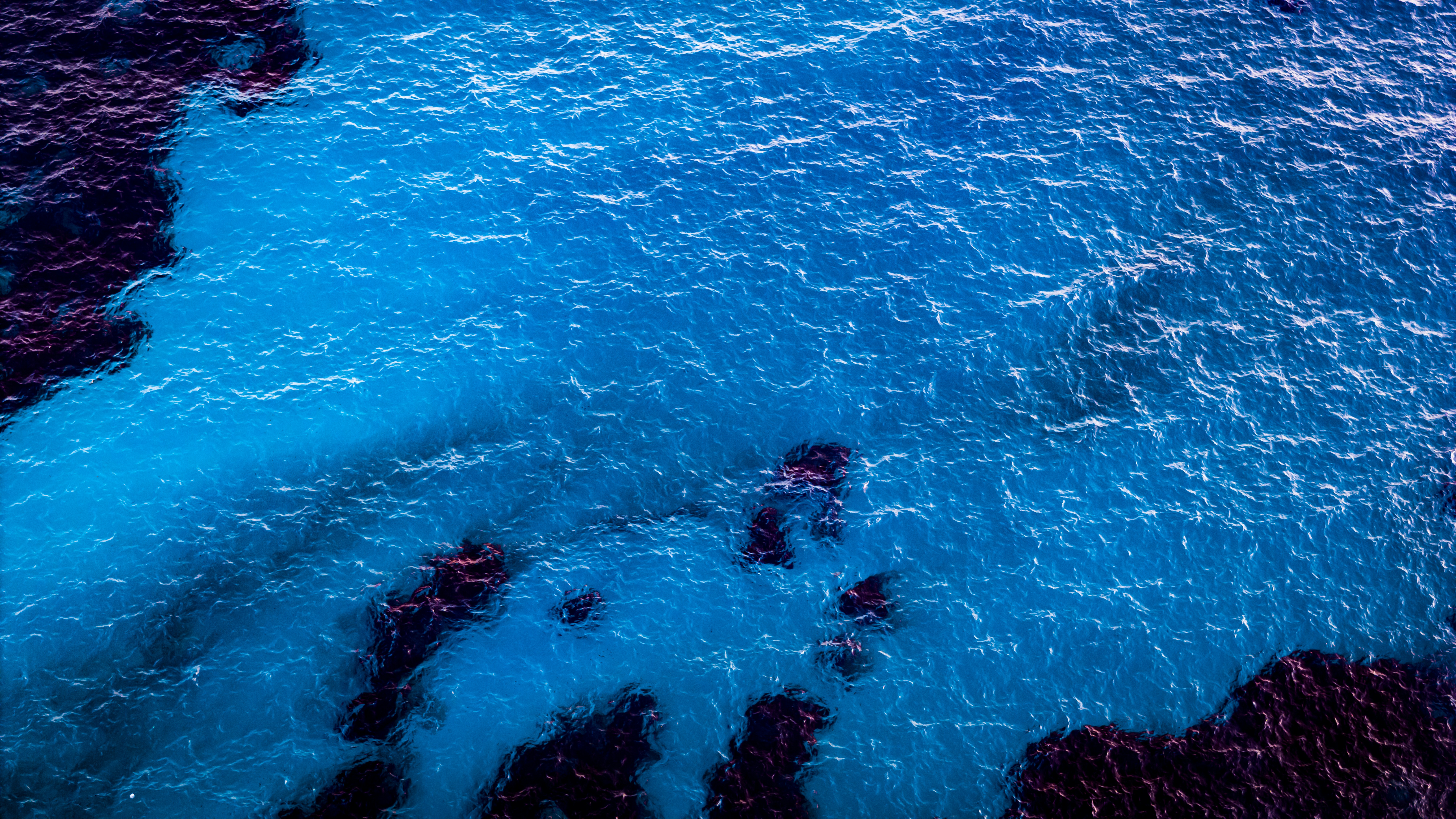View of blue transparent water sea from a drone