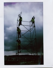 A group of trainees practicing safety protocols while working on scaffolding.