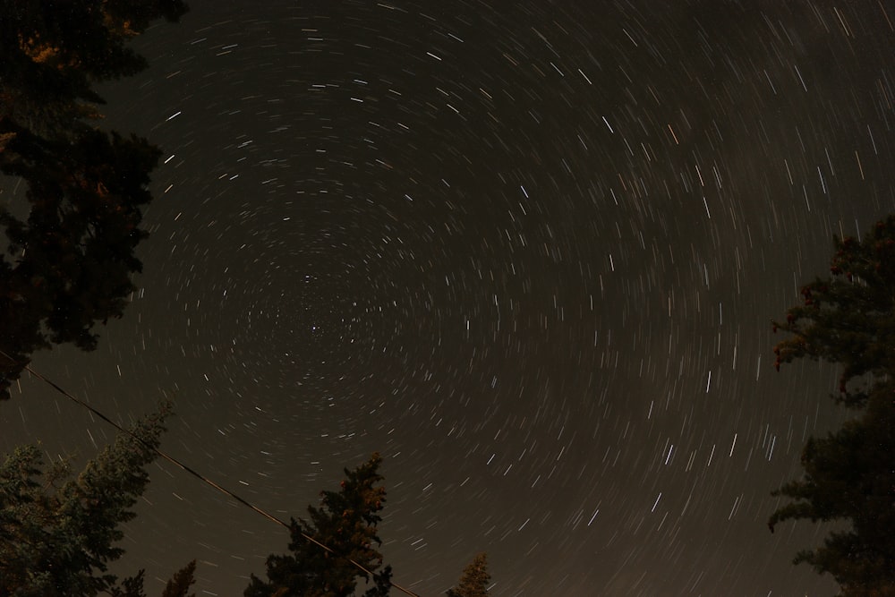 a night sky with a star trail in the sky