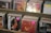 Several rows of music CDs arranged in a display shelf, with pink price stickers on some of them.