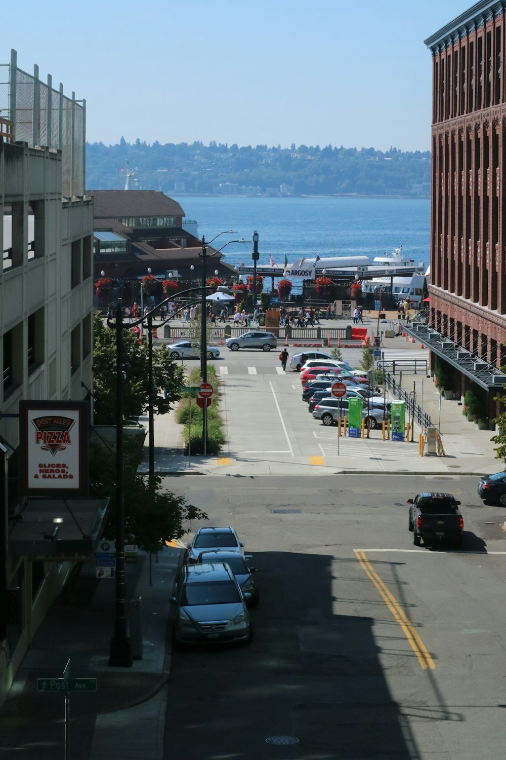 a city street filled with lots of traffic next to tall buildings