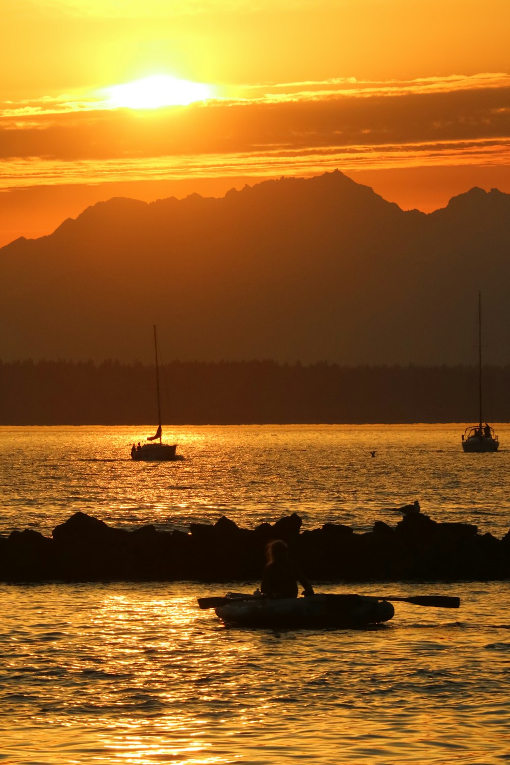 a couple of boats floating on top of a body of water