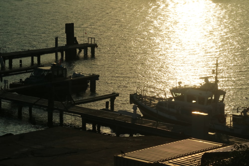 a boat is docked at a pier at sunset