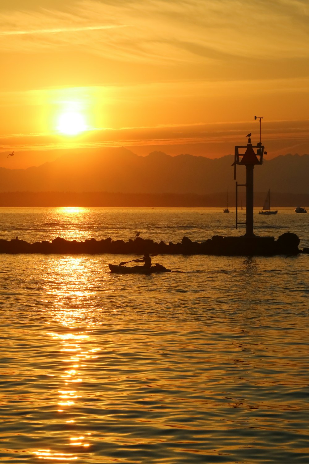 the sun is setting over a body of water