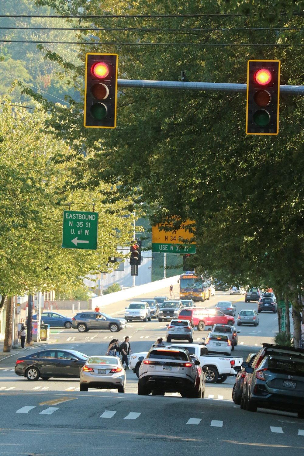 a traffic light hanging over a street filled with traffic