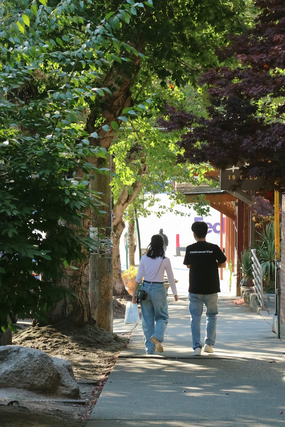 a man and a woman walking down a sidewalk