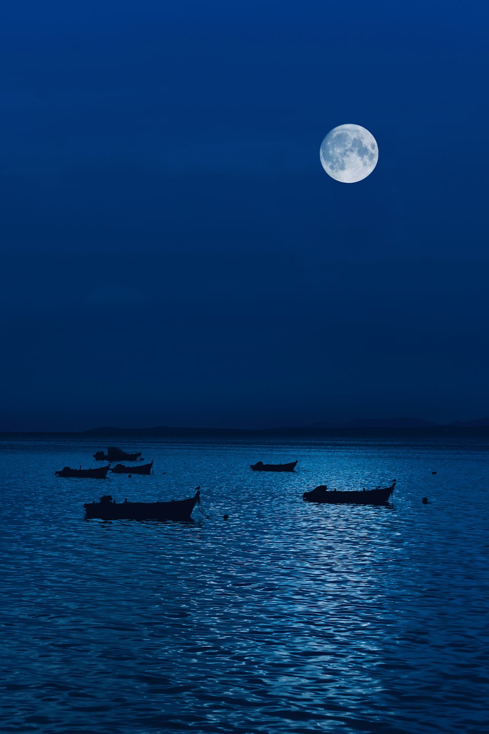 a group of boats floating on top of a large body of water