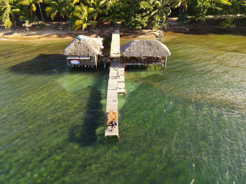 a couple of huts sitting on top of a pier