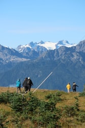 A group of friends trekking through lush green hills in the Himalayas.
