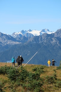 A group of friends trekking through lush green hills in the Himalayas.