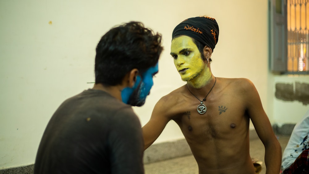 a man with a yellow face painted on his face