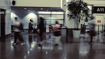 a group of people walking through an airport lobby